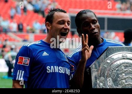 Chelsea's John Terry and Didier Drogba celebrates with the Community Shield trophy after winning the Community Shield soccer match between Manchester United and Chelsea at Wembley Stadium in London, Uk on August 9, 2009. Chelsea won 2-2 (4 penalties to 2). Photo by Henri Szwarc/ABACAPRESS.COM Stock Photo