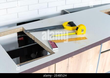 to cut holes in the kitchen countertop for equipment Stock Photo