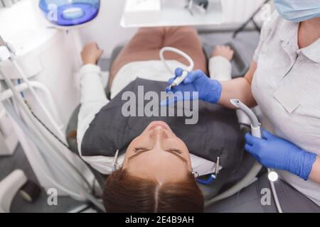 Top view cropped shot of female patient in dental chair during teeth examination Stock Photo