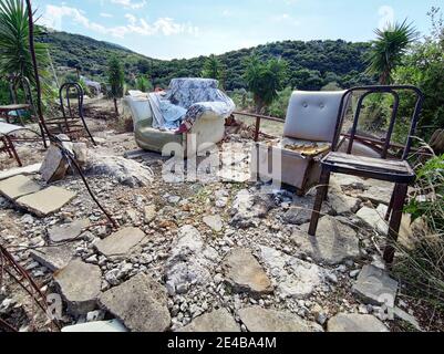 In the area of an unknown artist, among other things, there is furniture surrounded by chaos. Central Greece. Stock Photo