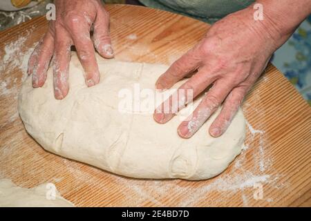 Grandmother kneading dough to prepare homemade bread and pastries at home,kitchen lifestyle Stock Photo