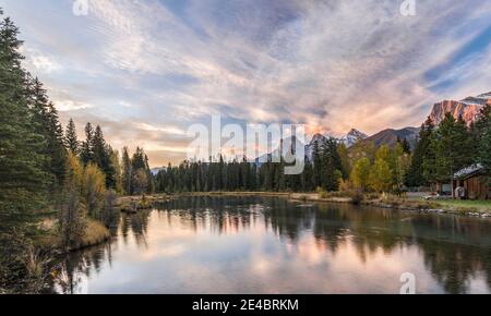 View of the Spring Creek Pond at sunset, Three Sisters, Mount Lawrence Grassi, Canmore, Alberta, Canada Stock Photo