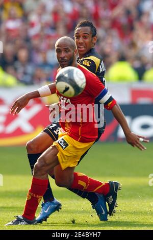 Lens' Eric Chelle fights for the ball with Lille's Pierre-Emerick Aubameyang during the French First League Soccer Match, RC Lens vs Lille OSC at Felix Bollaert Stadium in Lens, France on September 20, 2009. The match ended in a 1-1 draw. Photo by Mikael Stock Photo