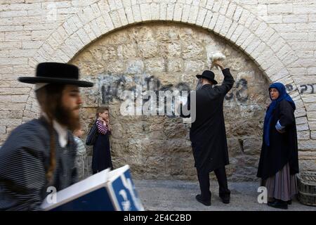 An ultra-Orthodox Jewish man swings a chicken, later to be slaughtered as part of the Kaparot ritual in which it is believed that one transfers one's sins from the past year into the chicken, in Mea Shearim religious neighborhood in Jerusalem, Thursday, September 24, 2009. The ritual is performed before the Day of Atonement, Yom Kippur, the holiest day in the Jewish year which starts at sundown Sunday. Photo by Olivier Fitoussi/ABACAPRESS.COM Stock Photo
