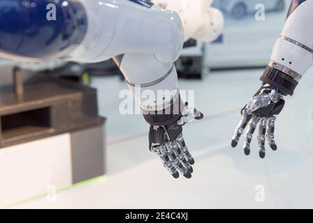 Communication between two robotic arms Stock Photo