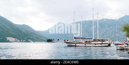 Large two-masted yachts moored at the pier in Perast, Montenegro. Stock Photo