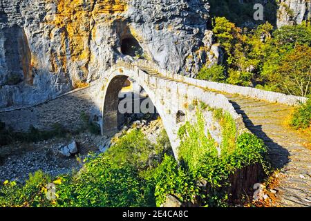 The single-arch Kokkoris stone bridge was built in 1750, it spans a narrow brook valley between two steep walls, mountainous region of Epirus, northern Greece