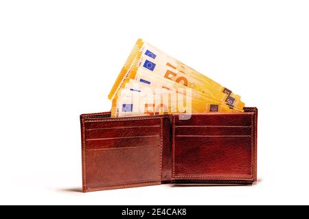Top view of New brown genuine leather made in italy wallet with fifty euro banknotes isolated on white background. Stock Photo