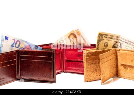 Top view of new brown genuine leather made in italy wallet with usd dollar, euro and chinese renminbi yuan banknotes isolated on white background. Stock Photo