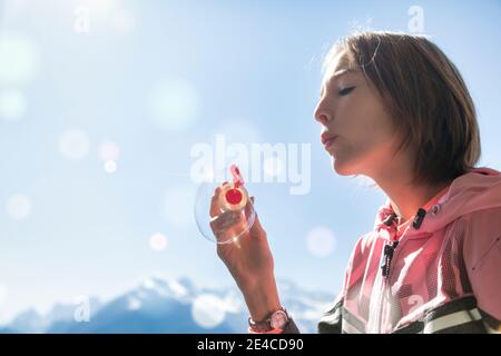 10 year old girl plays with soap bubbles Stock Photo