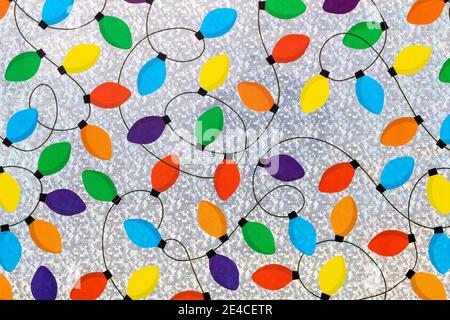 Colorful Christmas lights chain on a silver background. Stock Photo