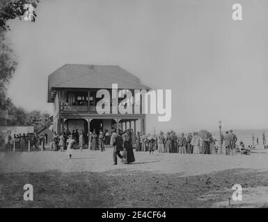 American archive monochrome photo of The Pavilion at Cayuga Lake Park, upstate NY, USA in August 1895. A crowd of people are outside and people are sitting on a wooden balcony enjoying a day out. Taken in the late 19th century Stock Photo