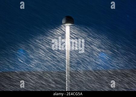 winter urban scene, street lamp lights up the night under a blizzard Stock Photo