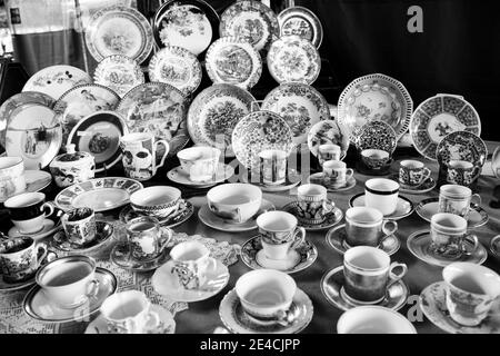 Sao Paulo / Sao Paulo / Brazil - 08 19 2018: Large group of elegant cups and plates with vivid texture displayed at a table. [Black and White] Stock Photo