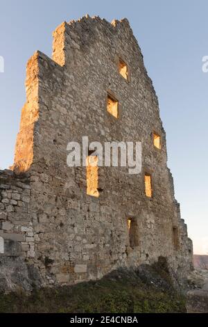 Europe, Baden-Wuerttemberg, Swabian Alb, biosphere area, Bad Urach, Schlossberg, Hohenurach ruin in the evening light, moon shines through window Stock Photo