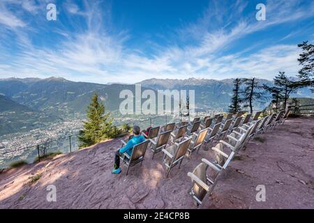 Verano, Province of Bolzano, South Tyrol, Italy. The Knottnkino on Rotsteinkogel, in the background the city of Merano and the peaks of the Texel group Stock Photo