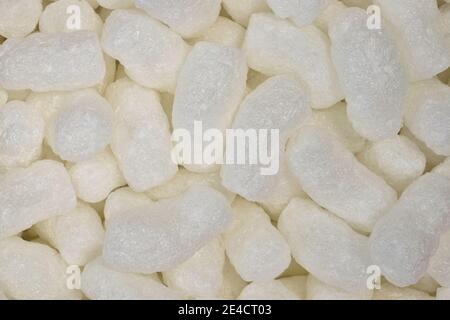 White packing peanuts styrofoam popcorn packaging material closeup flat lay. Stock Photo