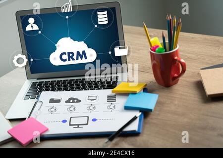 CRM Business Customer CRM Management Analysis Service Concept Business team hands at work with financial reports and a laptop Stock Photo