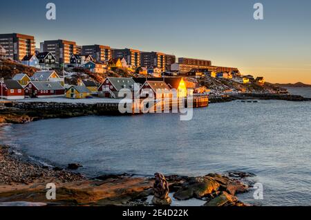 view from the Bay Area onto some of the skyscrapers in middle Greenland, the capital city of Nuuk at sunset in winter Stock Photo