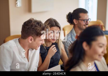 multiracial group of young people having fun at business seminar, talking, smiling Stock Photo