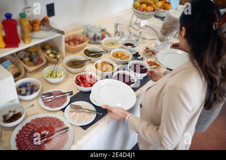 top view of breakfast buffet with diverse choice of food served in dishes on table Stock Photo