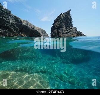 Seascape Mediterranean sea, rugged rock and rocky coast, split view half over and under water, Cap Cerbere at the border between Spain and France Stock Photo