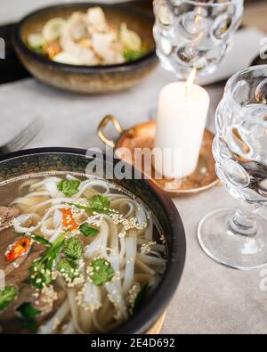 Served table with pho bo soup in a bowl  Stock Photo