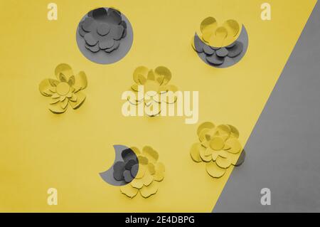 image of paper flowers in fresh yellow color with ultimate grey details as Moon phases Stock Photo