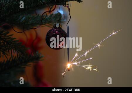 Burning sparkler and Christmas Bauble Stock Photo