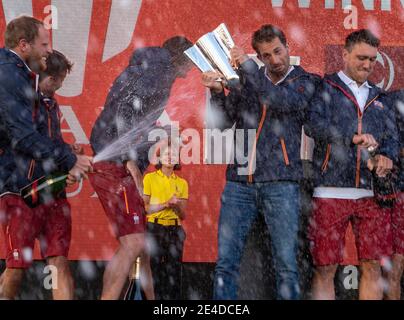 Auckland, New Zealand, 23 January, 2021 -  INEOS Team UK skipper Sr Ben Ainslie is sprayed with champagne by team mates at the trophy presentation after beating Italian team Luna Rossa Prada Pirelli on the Waitemata Harbour in Auckland to progress directly to the Prada Cup Final. Credit: Rob Taggart/Alamy Live News Stock Photo