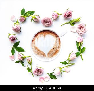 Morning coffee and beautiful rose flowers on pink pastel table top view.  Cozy breakfast for Womens or Valentines day. Flat lay. Stock Photo
