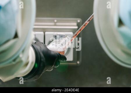 (210123) -- BEIJING, Jan. 23, 2021 (Xinhua) -- Staff members work at the high-level biosafety protective zone in the COVID-19 vaccine stock solution workshop soon to be put into operation at Sinovac Life Sciences Co., Ltd. in Beijing, capital of China, July 15, 2020. In late 2019, the novel coronavirus emerged and rapidly spread across the world. Tens of millions of people have been infected. Scientists isolated the virus from patients and named the virus COVID-19. As the coronavirus wreaks havoc on the world, vaccine has become a hope for humanity to conquer the pandemic. Scientists cultivate Stock Photo