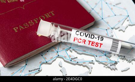 COVID-19, travel and test concept, tube for coronavirus PCR testing and tourist passport on Europe map. Coronavirus diagnostics due to restrictions an Stock Photo