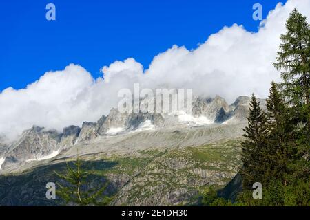Peak of Care Alto (3462 m) with clouds in the National Park of Adamello Brenta. Trentino Alto Adige, Italy Stock Photo