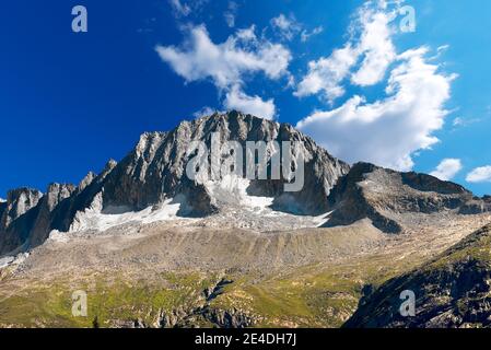 Peak of Care Alto (3462 m) with clouds in the National Park of Adamello Brenta. Trentino Alto Adige, Italy Stock Photo