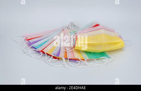 colored medical masks on a white background. sterile bandages on the face to protect against viruses and infections Stock Photo