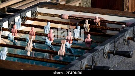 an old rusty table football in a bar on the Ligurian Riviera del Ponente during a winter day Stock Photo