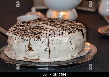 A gluten-free cream cake with pear filling served on a nicely laid table. Stock Photo