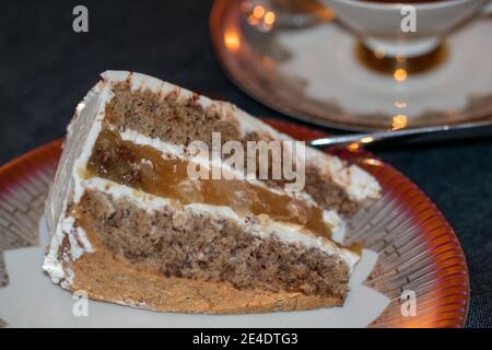 A gluten-free cream cake with pear filling served on a nicely laid table. Stock Photo