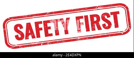 SAFETY FIRST text on red grungy rectangle stamp. Stock Photo