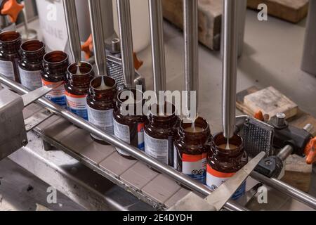 Glue bottles being filled and packaged, Philadelphia, USA Stock Photo