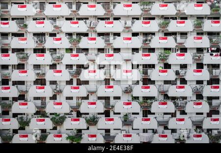 National flag of Singapore at HDB in Singapore to celebrate the National Day. The National Day of Singapore is celebrated every year on August 9. Stock Photo