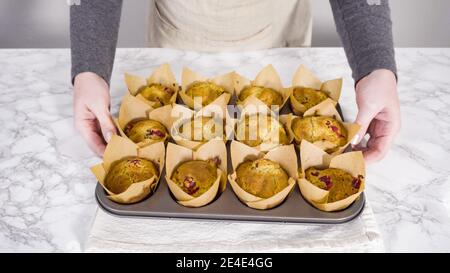 Step by step. Cooling freshly baked cranberry muffins. Stock Photo