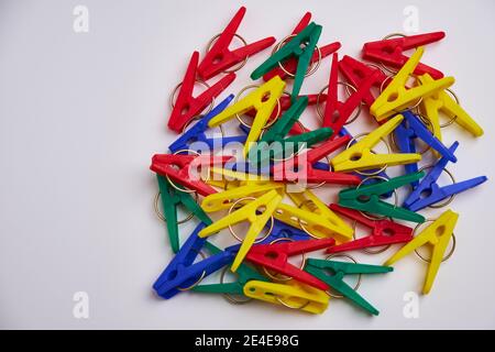 Multicolor laundry clips on white background, top view of colorful laundry clips Stock Photo