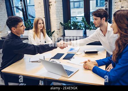 businessmen shaking hands in office Stock Photo