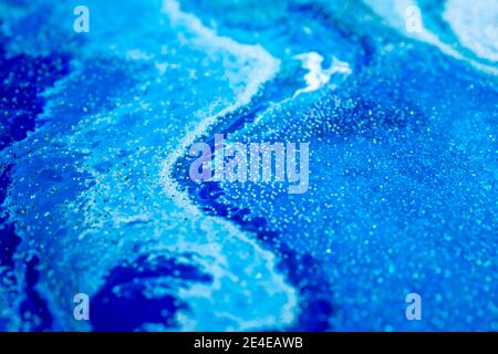 Selective focus. Blue creative abstract painted background, wallpaper, acrylic painting on canvas. Texture art. Blue paint with gold glitter powder. Marble background Stock Photo