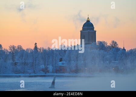 Arrival by ferry to the Suomenlinna fortress island on an extremely cold winter morning at sunrise with sea fog and icy Baltic sea, the Suomenlinna ch