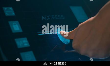 Close up human finger is touching interface computer monitor, fingerprint biometric identity and approval.  future security and password control throu Stock Photo