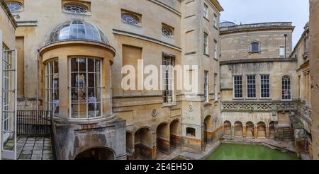 The curved Pump Room window and the Sacred Pool at the Roman Baths museum, a major tourist attraction in the City of Bath, Somerset, southwest England Stock Photo
