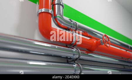 Red and metallic pipelines across a white wall with green accent line. Clean, modern industrial background. Digital render. Stock Photo